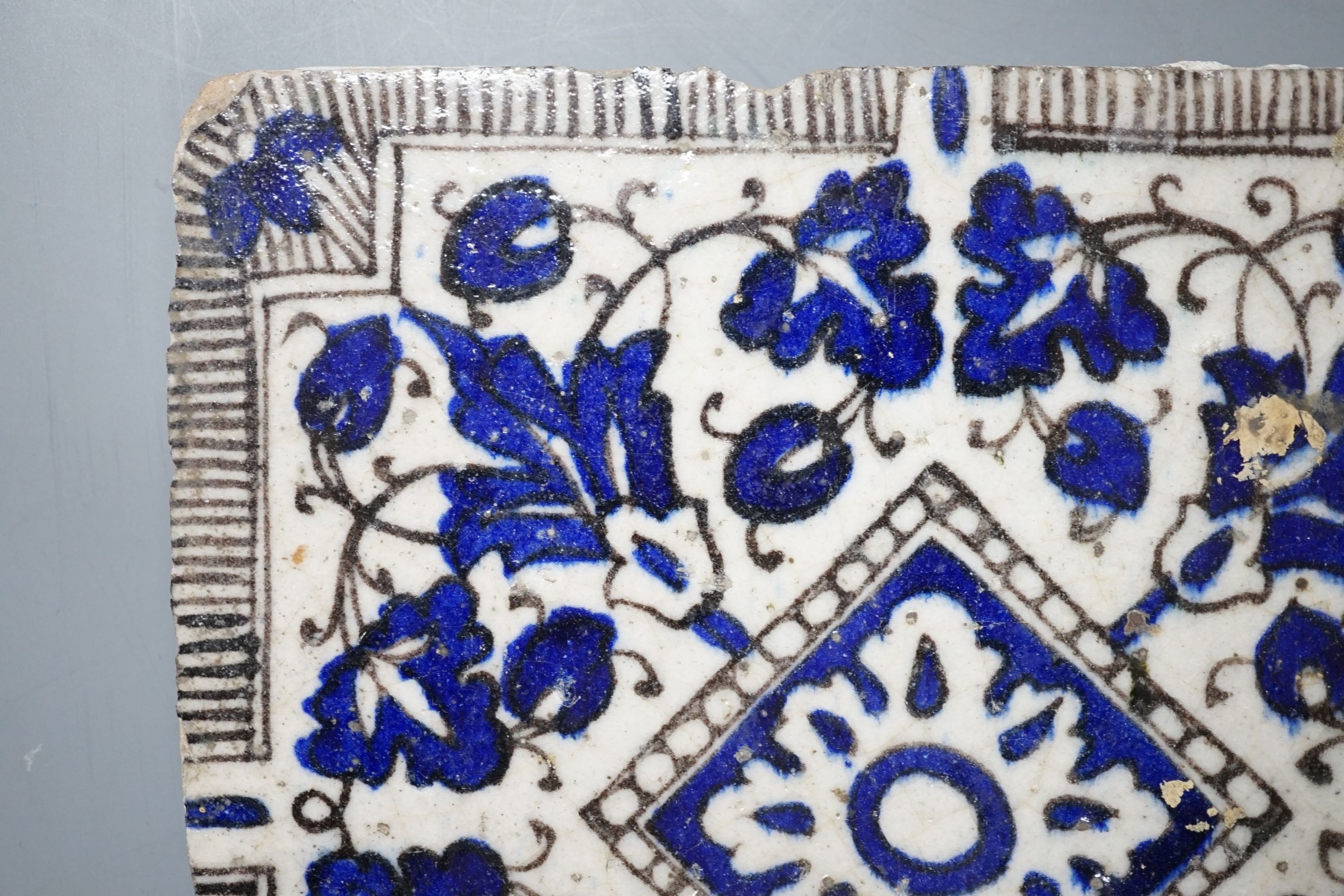 A Persian blue and white ceramic tile - 21 x 20cm